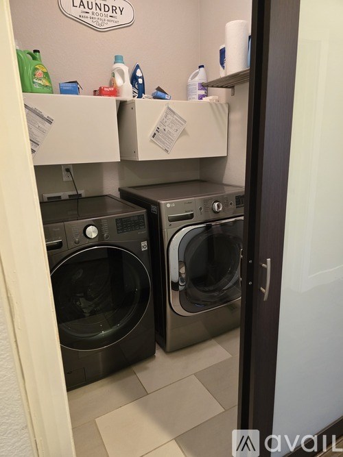 A laundry room with two front loading washing machines.