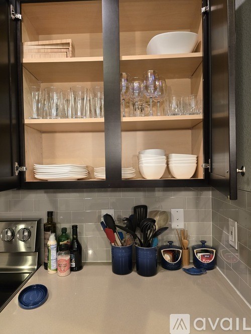 A kitchen with black cabinets and a white countertop.