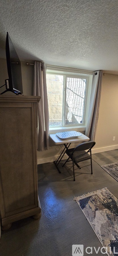 A room with a chair and a window.