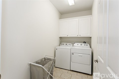 A small laundry room with a washer and dryer.