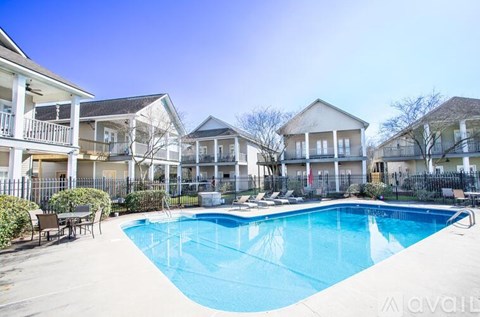 A swimming pool in front of a row of houses.