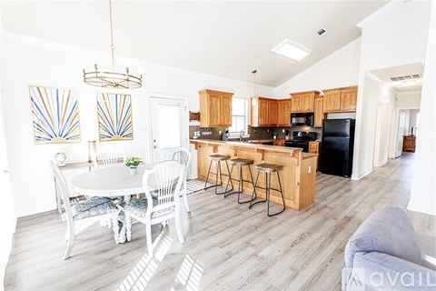 A kitchen with a bar and a dining table.