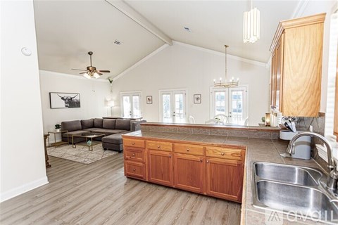 A kitchen with a wooden counter and a sink.