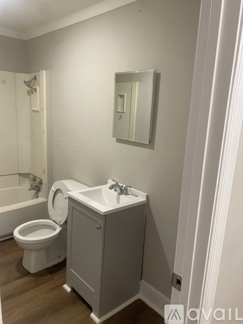 A white toilet sits next to a sink in a bathroom.