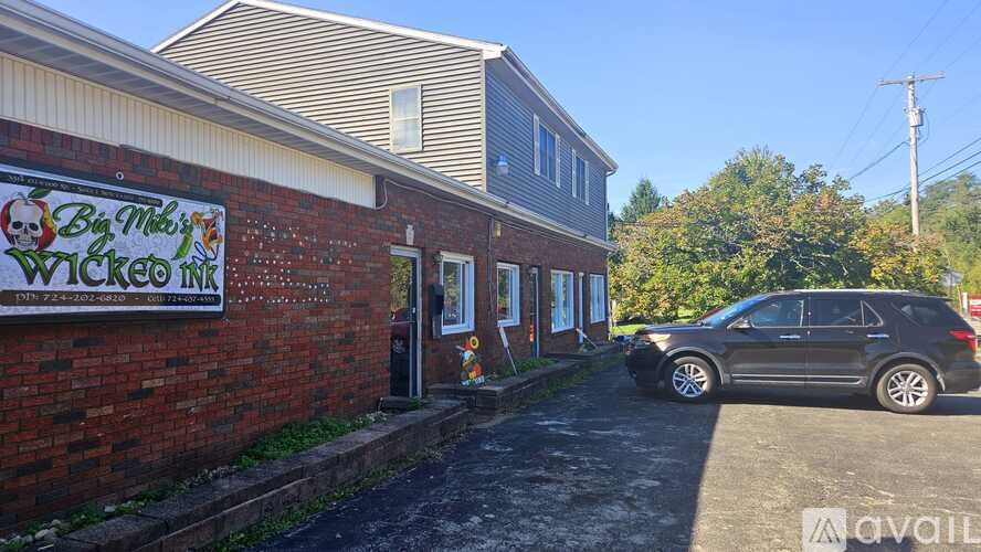 A brick building with a sign that says "Bang This Wicked Inn".