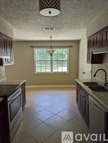 A kitchen with a window and a sink.