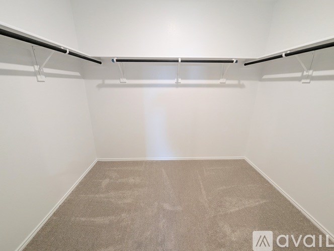 A room with a carpeted floor and white walls.