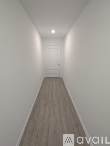 A long hallway with a door at the end.