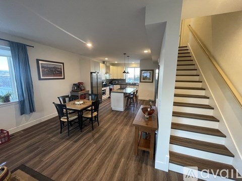 A living room with a dining table and chairs.