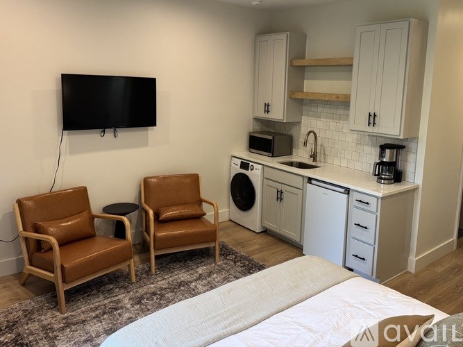 A small kitchen with a microwave, oven, and sink.