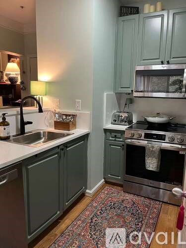 A kitchen with a stove and sink.