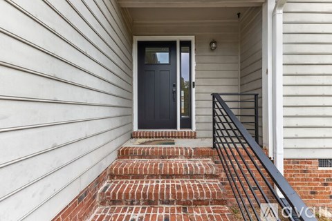 A kitchen with a refrigerator, sink, and cabinets.