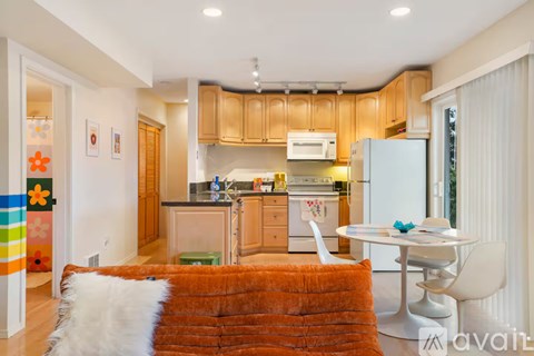 A kitchen with wooden cabinets and a white refrigerator.