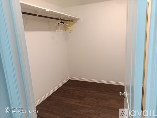 A room with a white wall and a wooden floor.