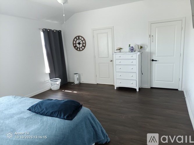 A bedroom with a bed, dresser, and mirror.