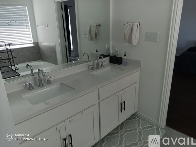A bathroom with a white sink and a mirror.