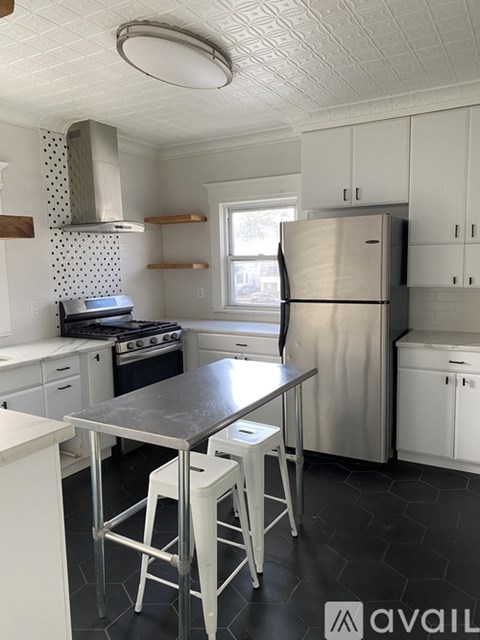 A kitchen with a table and chairs in the middle of it.