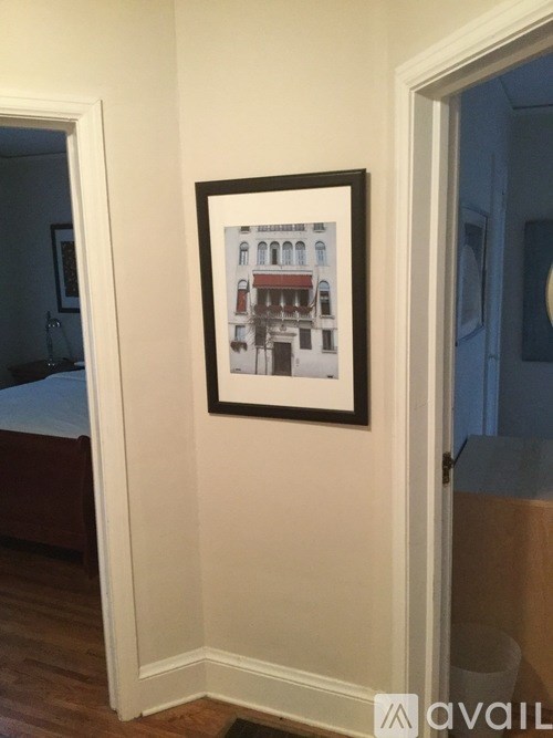 A picture of a building is hanging on a wall.