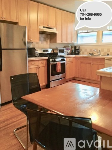 A kitchen with wooden cabinets and a refrigerator.