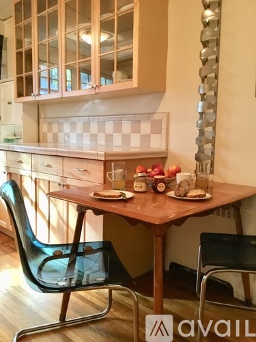 A kitchen with a table and chairs.