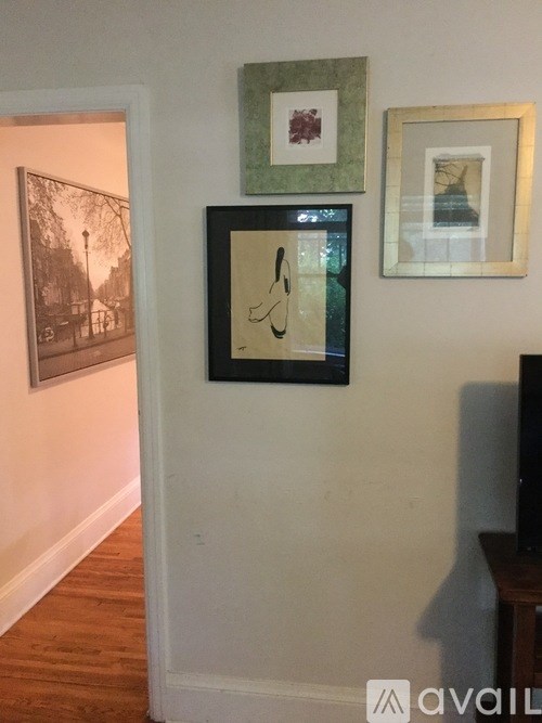 Three framed pictures hang on a wall.