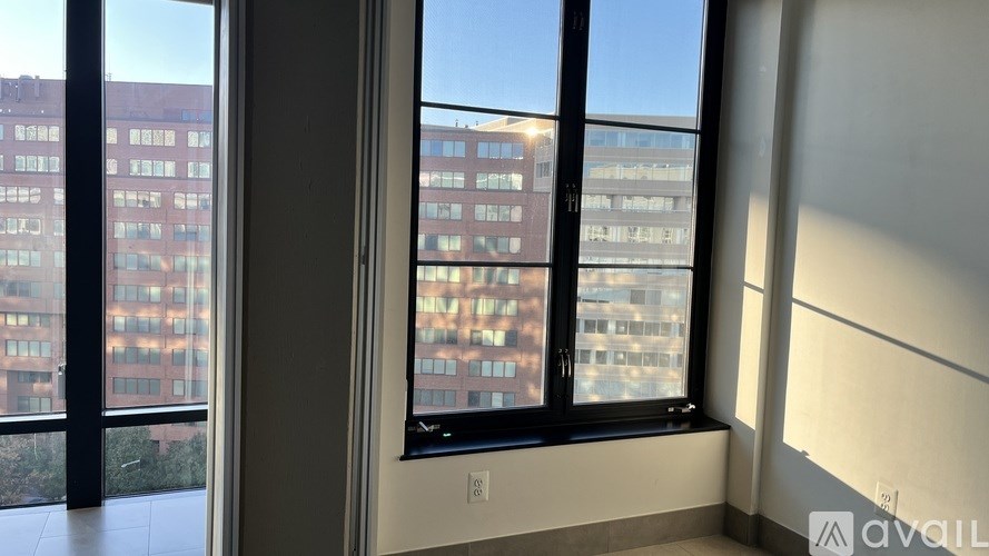 A room with a large window overlooking a cityscape.
