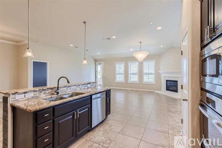 A modern kitchen with a marble countertop and a large island.
