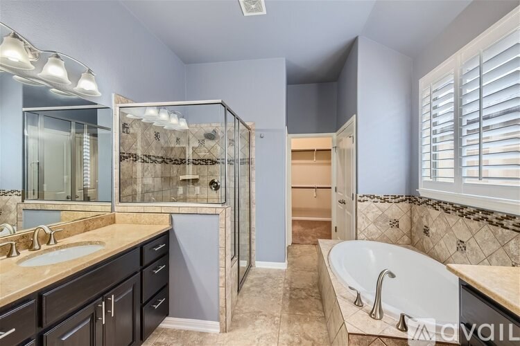 A bathroom with a large tub and a walk-in shower.