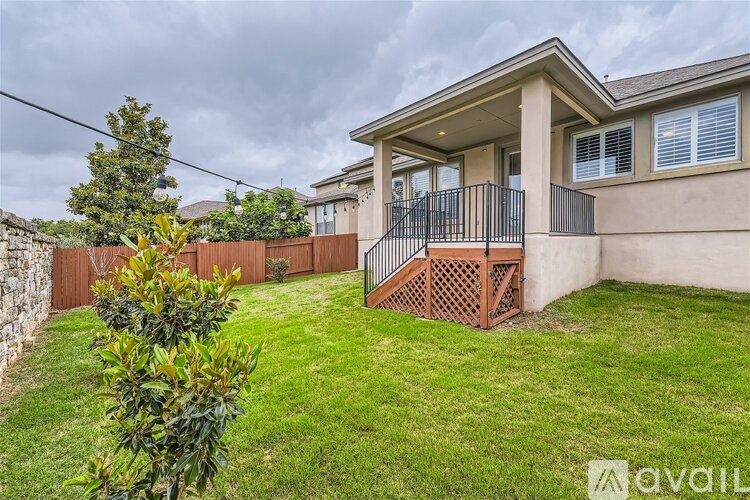 A house with a brown fence and a green lawn.
