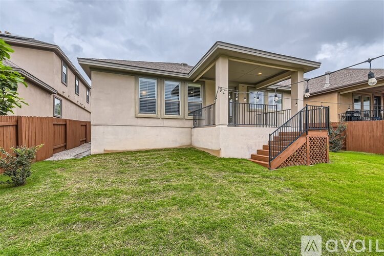 A house with a front yard and a deck.