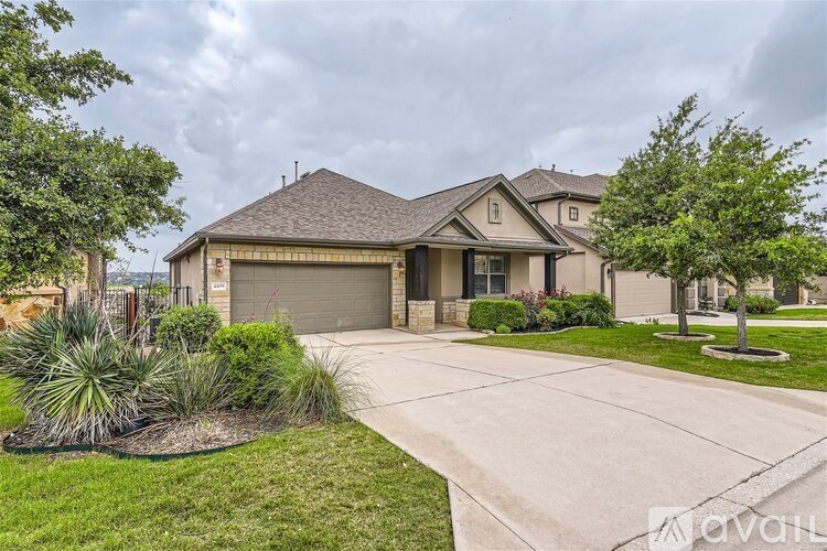A house with a driveway and a landscaped yard.