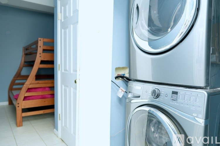 A washing machine is in front of a closed door.