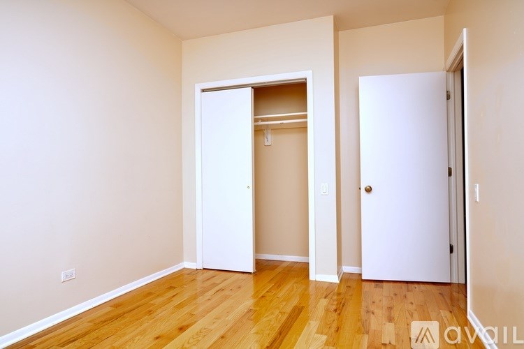 A room with a white door and a white wall.