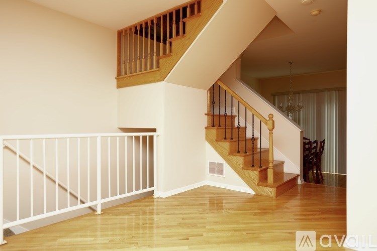A wooden staircase with a white railing.
