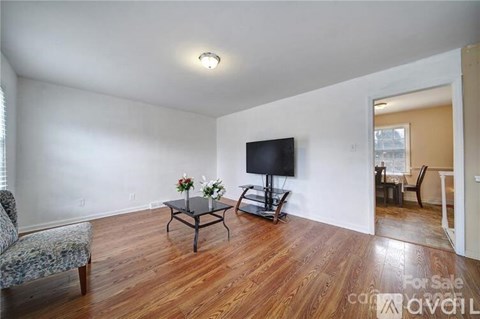 A living room with a sofa, coffee table, and television.