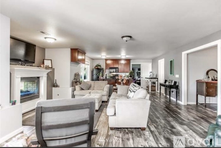 A spacious living room with a fireplace and a television.