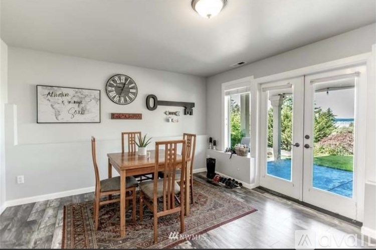 A dining room with a wooden table and chairs.
