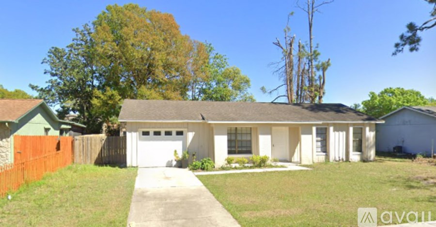 A house with a white garage door is for sale.