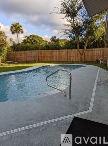 A pool with a diving board in the middle of it.
