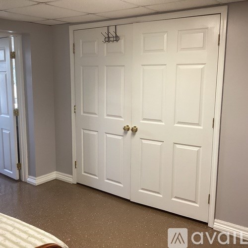 A white door with a gold handle is closed.