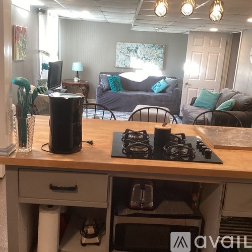 A kitchen area with a stove top oven and a counter.