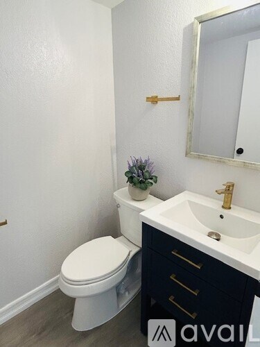 A white toilet sits next to a sink in a bathroom.