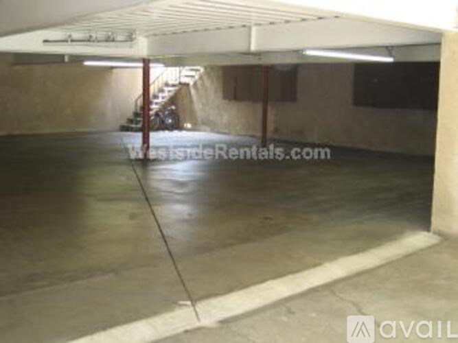 A spacious garage with a concrete floor and a white ceiling.