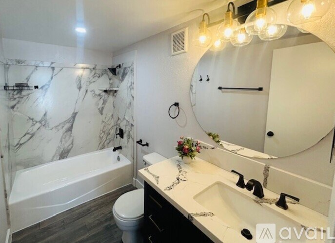 A bathroom with marble walls and a white toilet.