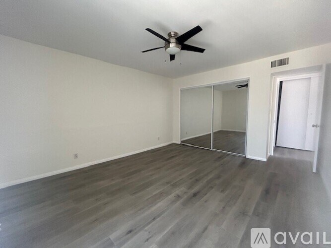 A room with a ceiling fan and a sliding door.