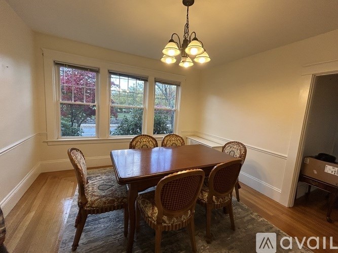 A dining room with a table and chairs.