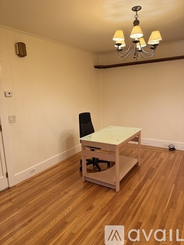 A room with a wooden floor and a chandelier.