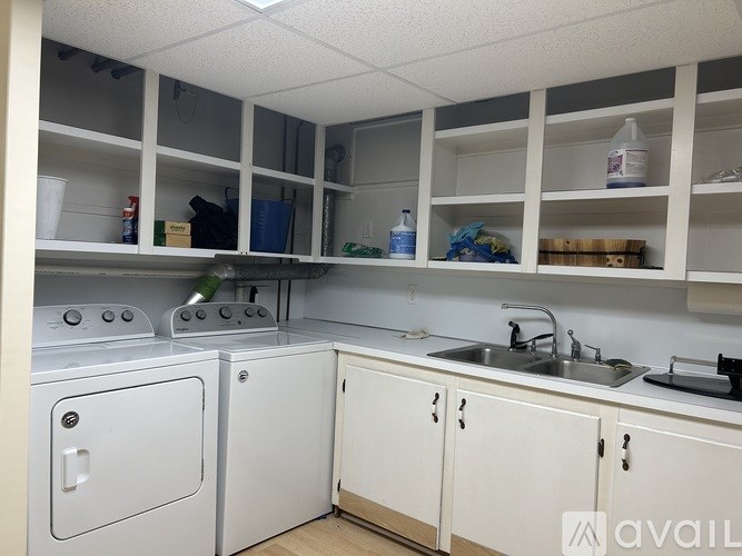 A small, clean kitchen with white appliances and cabinets.