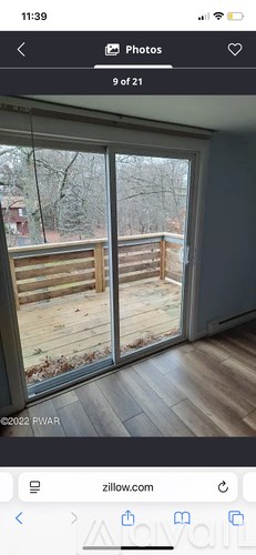 A view of a deck through a sliding glass door.