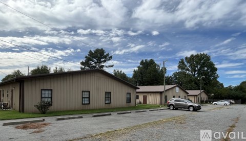 A building with a parking lot in front of it.